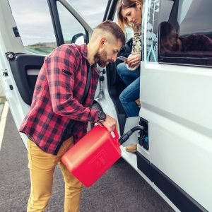 Man refueling his camper van with a jerrycan
